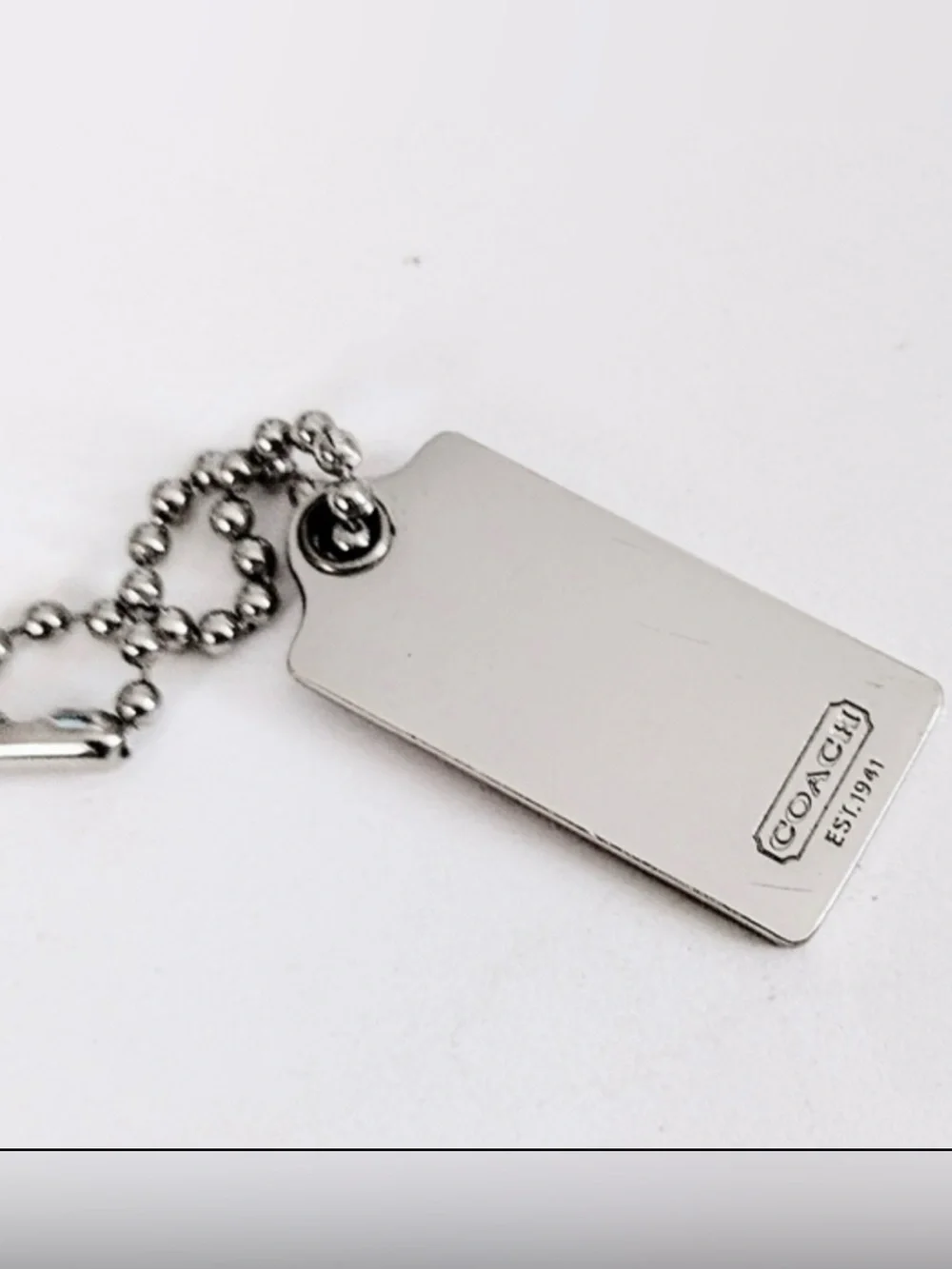Coach Silver Tone Embossed Horse & Carriage Dog Tag Keychain